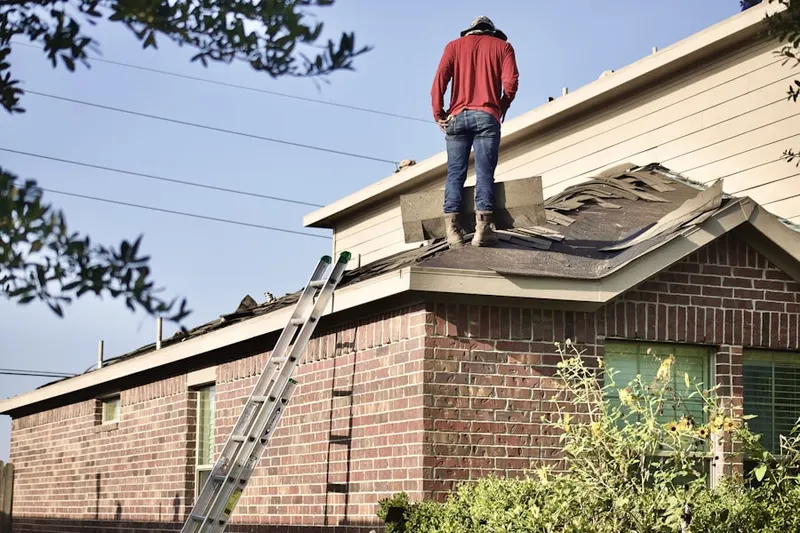 Professional roofer working on a residential roof in Bungalow Heaven